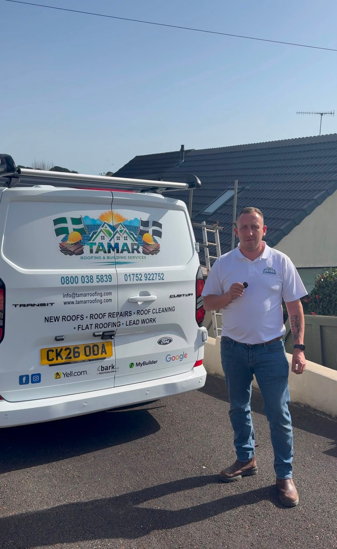 Lewis from Tamar Roofing & Building Services standing beside his branded work van